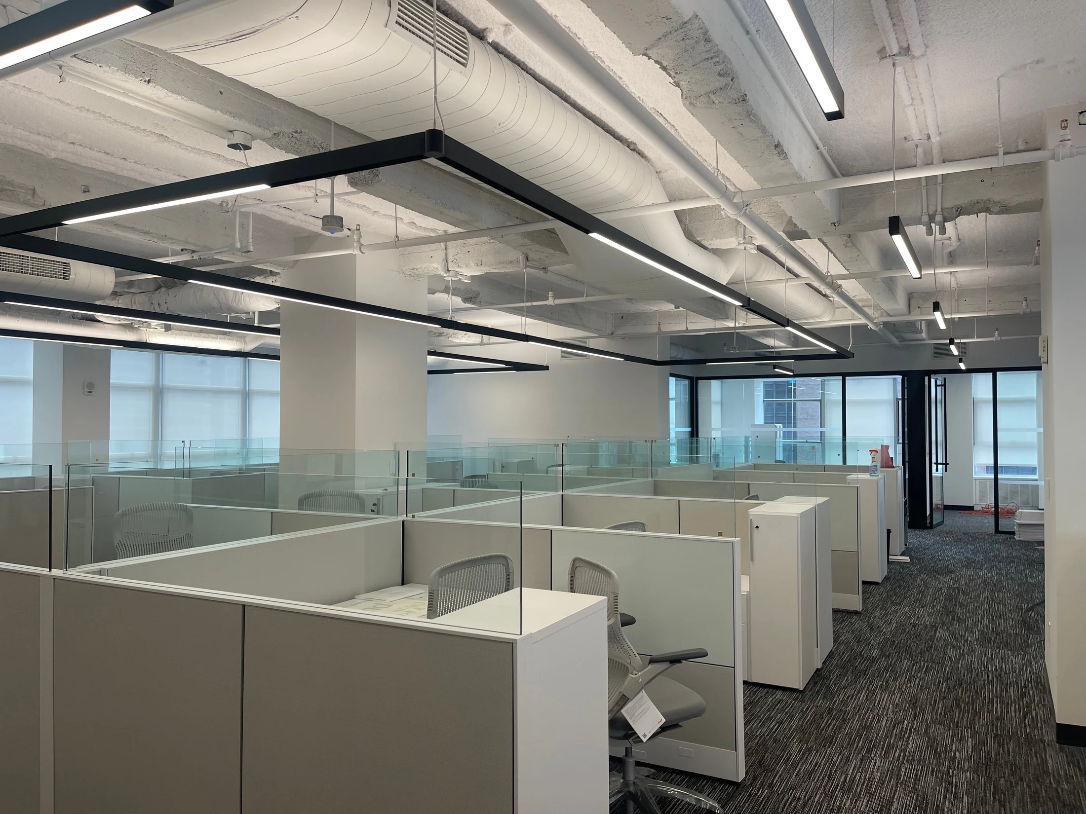 Newly fitted office with glass-partitioned workstations