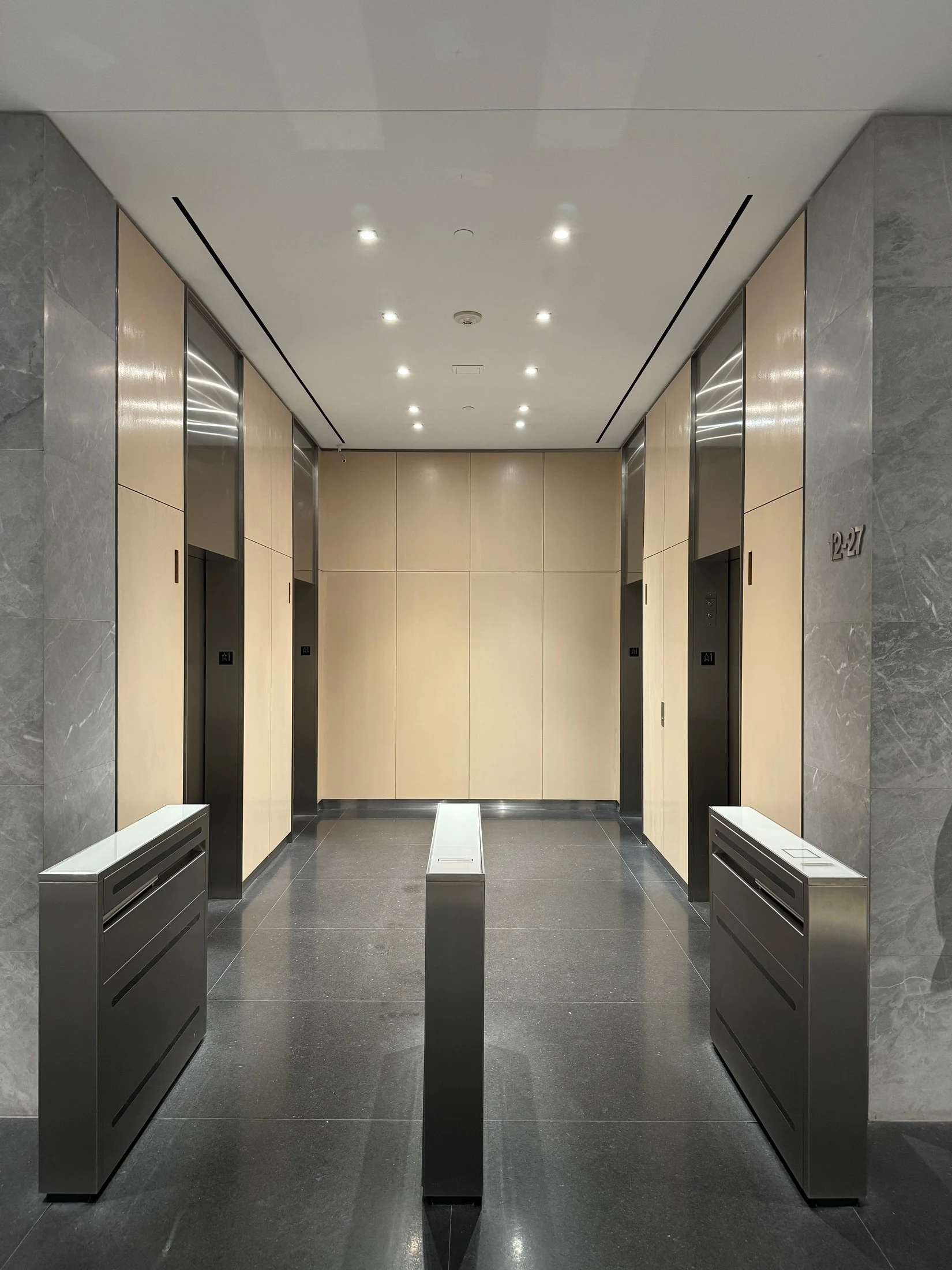 The completed elevator lobby with restored wood panels and clean stone floors